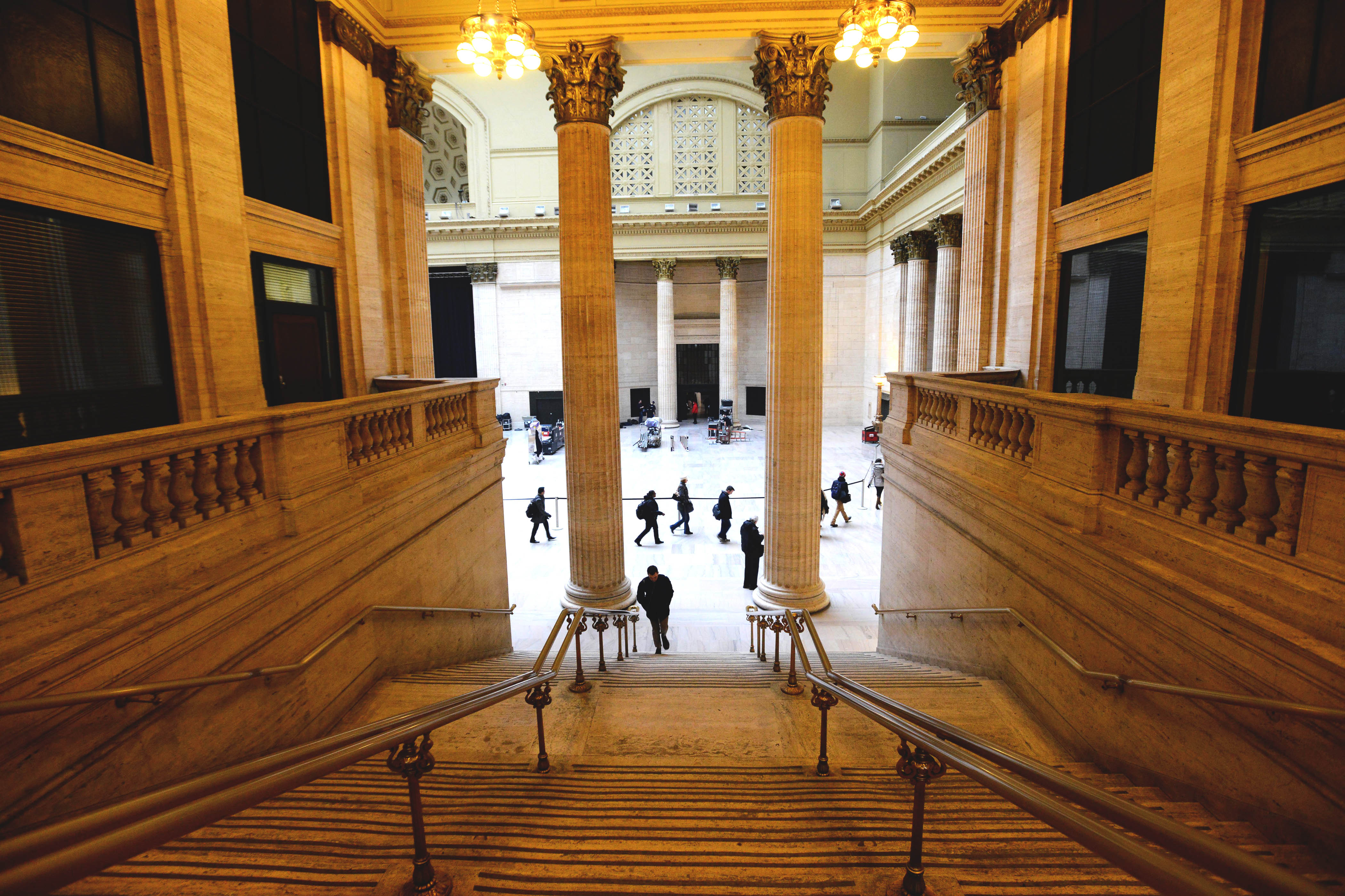 View inside Union Station Chicago of the tall ceilings above a staircase in the main hall with tall columns