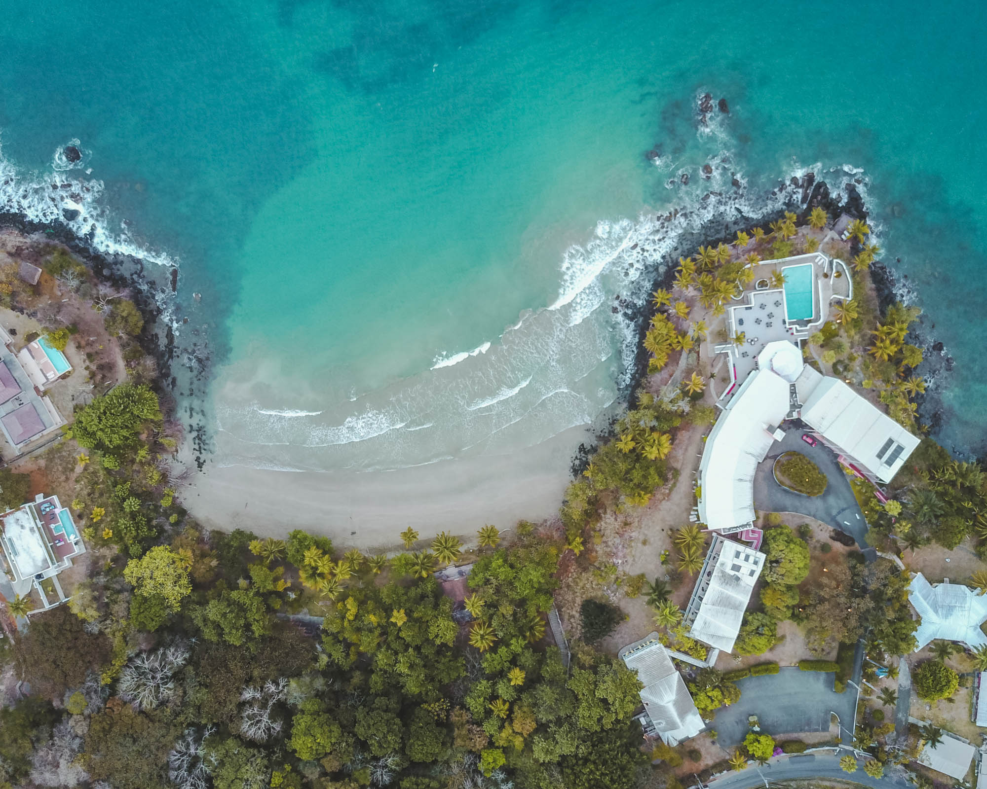 Trinidad and Tobago drone shot over buildings and cove 