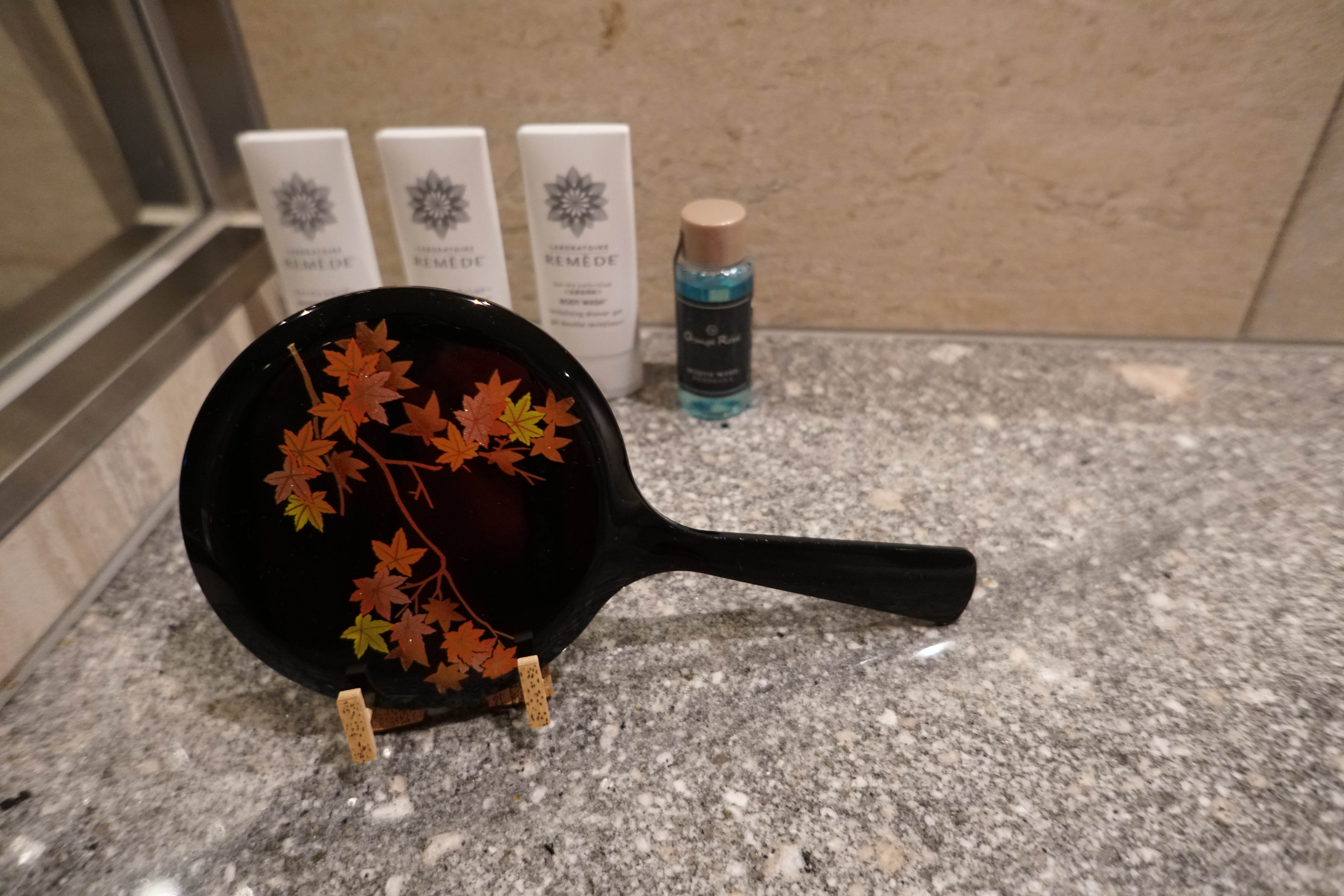 decorative mirror in the bathroom with fall leaves