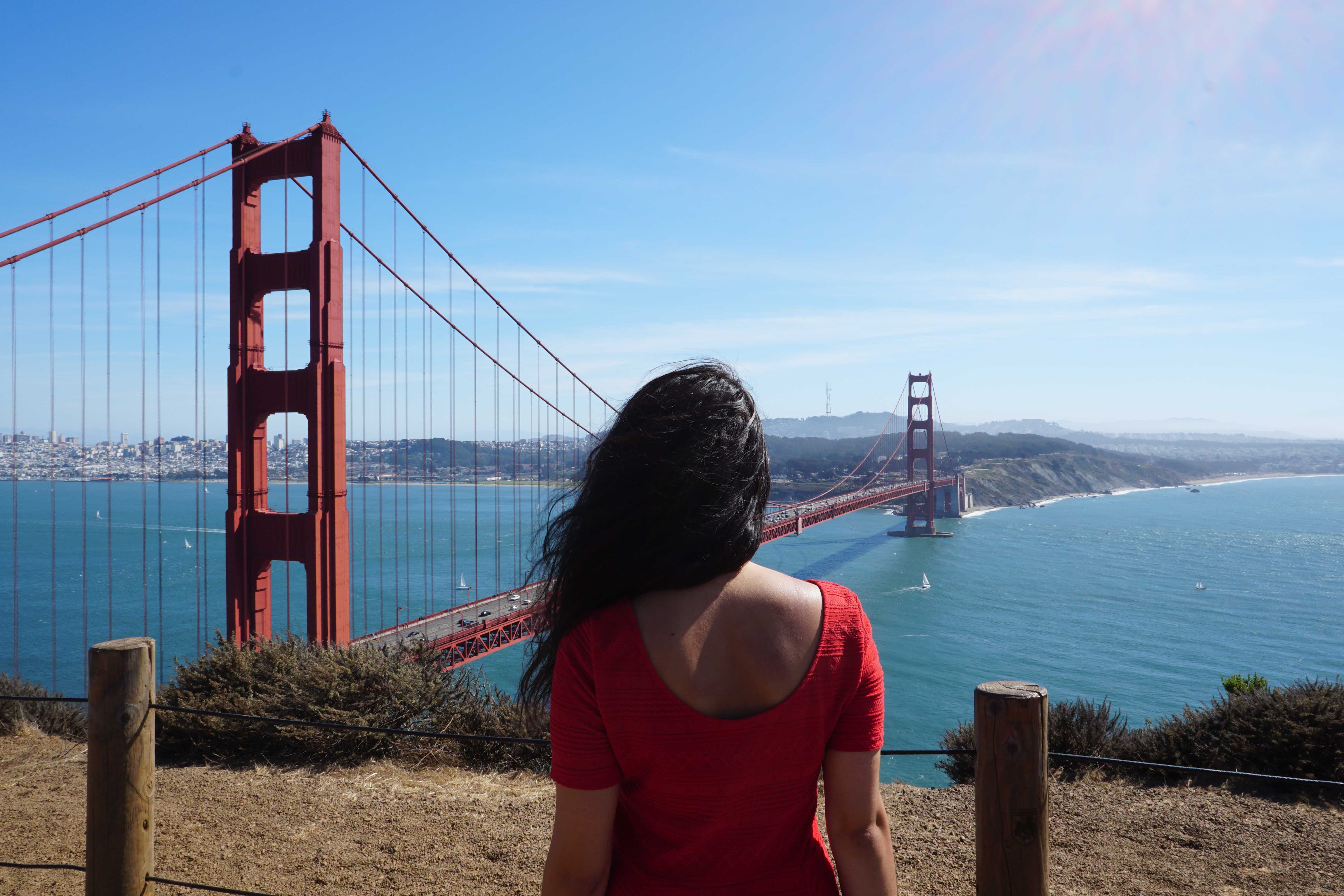 woman in red in front of the San Francisco Golden Gate Bridge Jennifer O'Brien The Travel Women